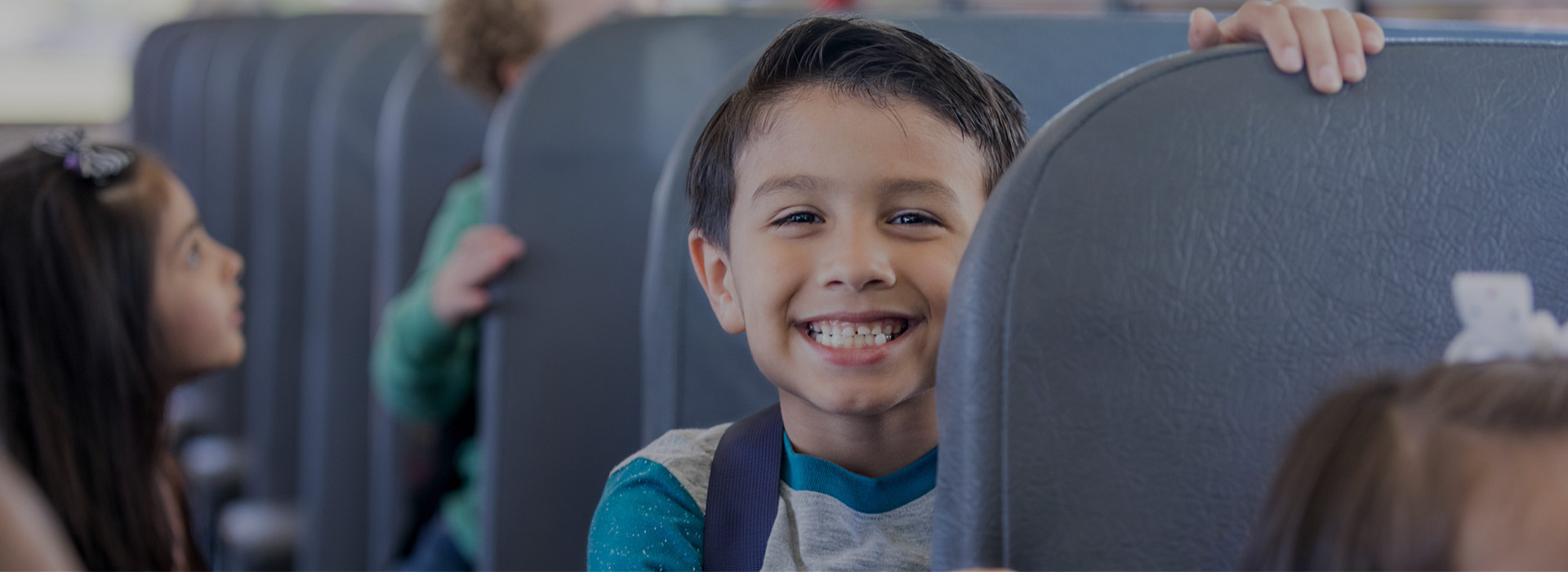Slajd 3 - uśmiechnięty chłopiec w autobusie